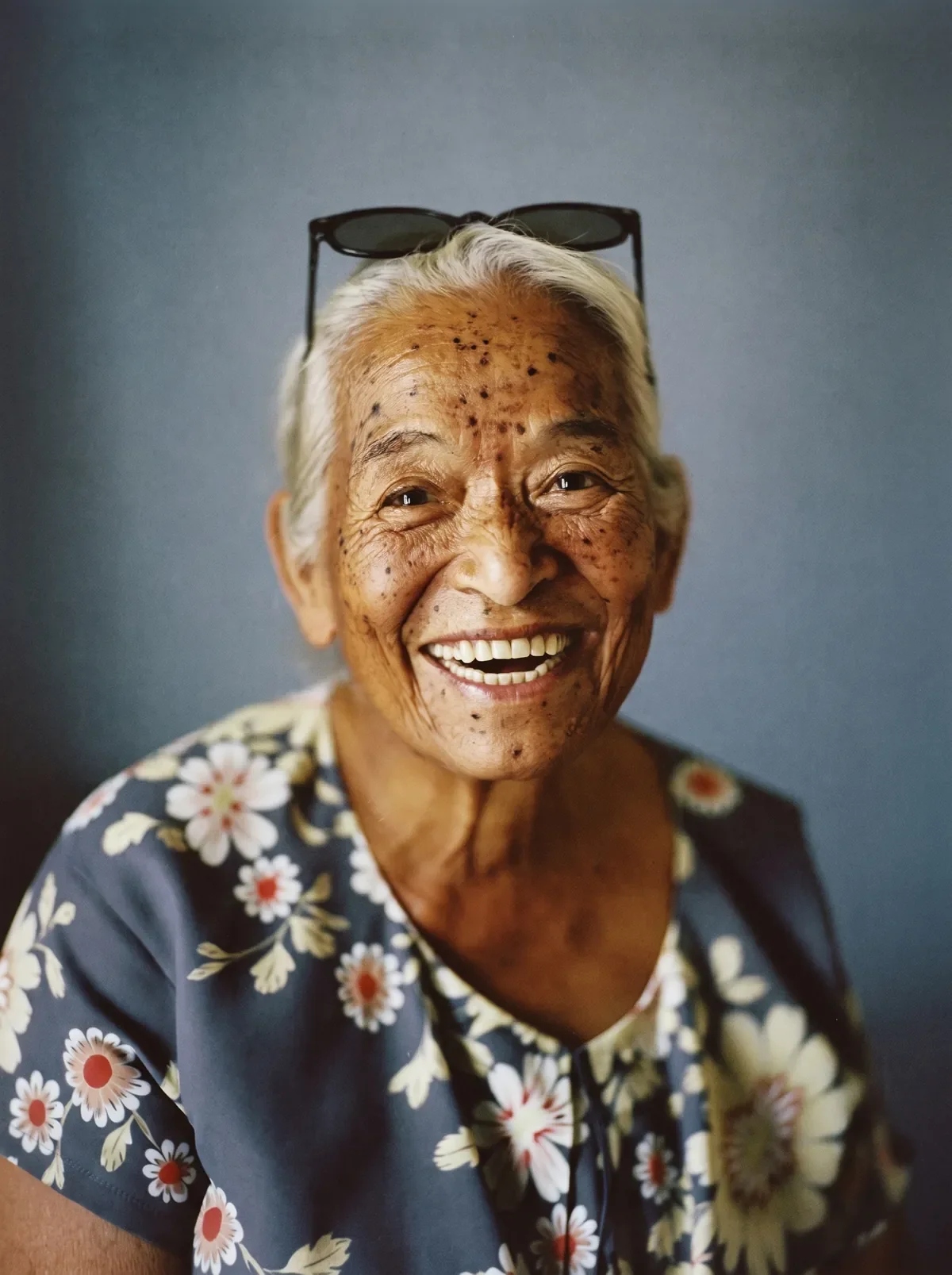 Grandmother smiling, photographed against a plain backdrop