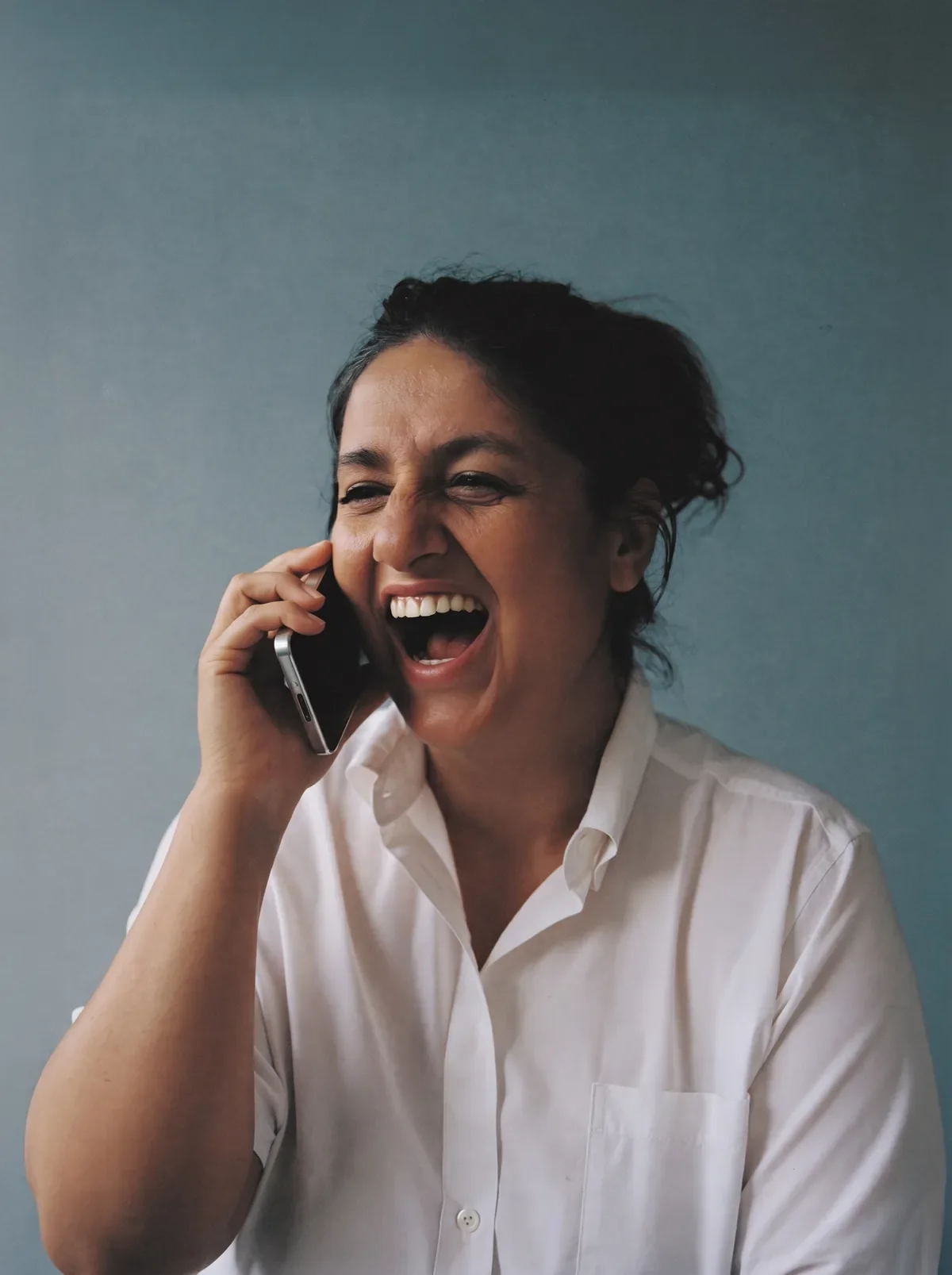 Woman laughing during a phone call
